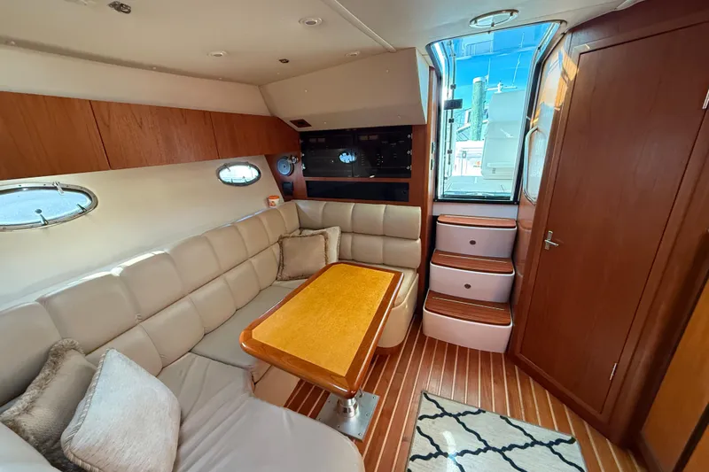 Slide: The Image of Luxurious interior of 2003 Tiara Yachts 3500 Open with plush seating and wooden accents. - 23