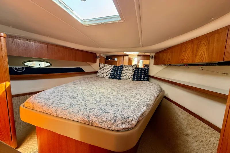 Slide: The Image of Luxurious cabin interior of 2003 Tiara Yachts 3500 Open with cozy bedding. - 27