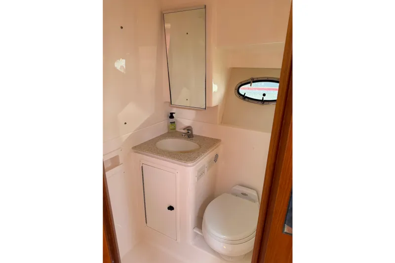 Slide: The Image of 2003 Tiara Yachts 3500 Open bathroom with sink, mirror, and toilet. - 28