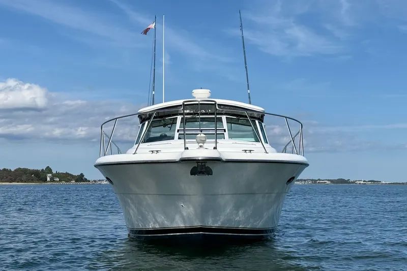 Slide: The Image of 2003 Tiara Yachts 3500 Open on calm water, front view under blue sky. - 3