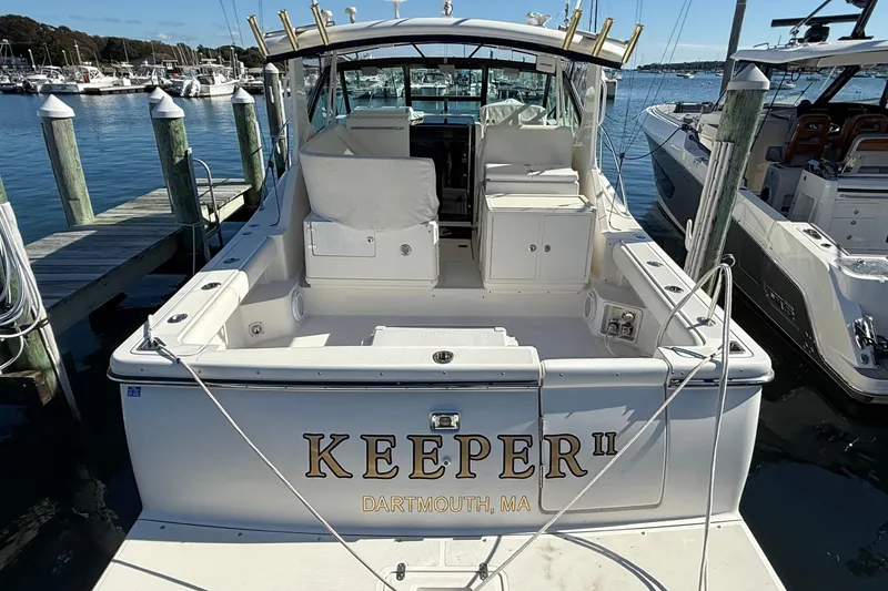 Slide: The Image of 2003 Tiara Yachts 3500 Open docked, rear view, with "KEEPER II" name visible. - 8