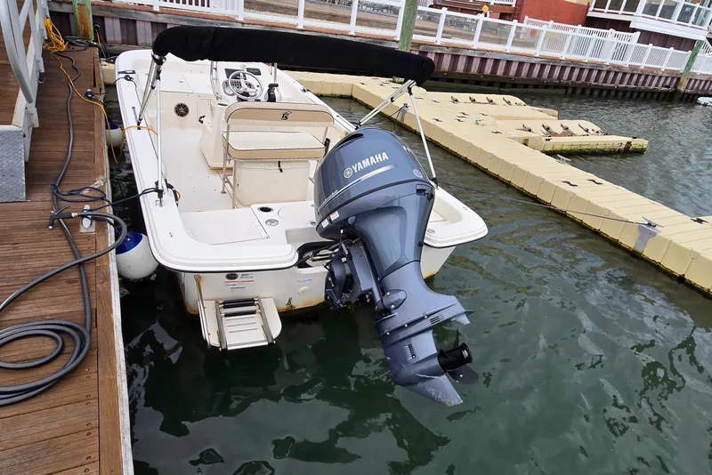 Slide: The Image of View of foldable Bimini cover, helm leaning post, cooler, aft seating folded away and 115 hp Yamaha - 10