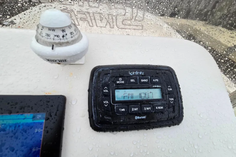 Slide: The Image of 2021 Carolina Skiff 19 LS dashboard with compass and Infinity radio. - 15