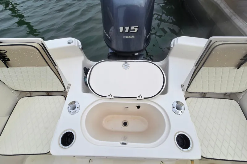 Slide: The Image of 2021 Carolina Skiff 19 LS boat interior with Yamaha 115 engine, featuring seating and aft live well. - 18
