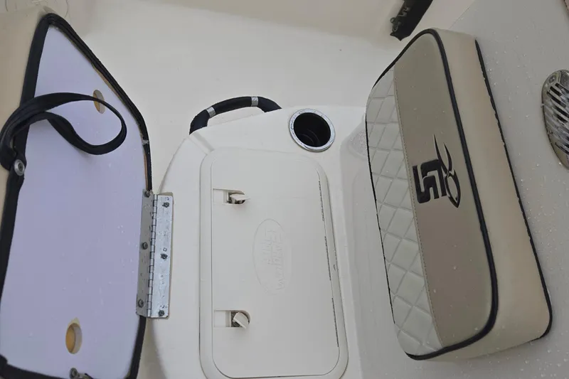 Slide: The Image of 2021 Carolina Skiff 19 LS boat interior with storage compartment and cushioned seating. - 21