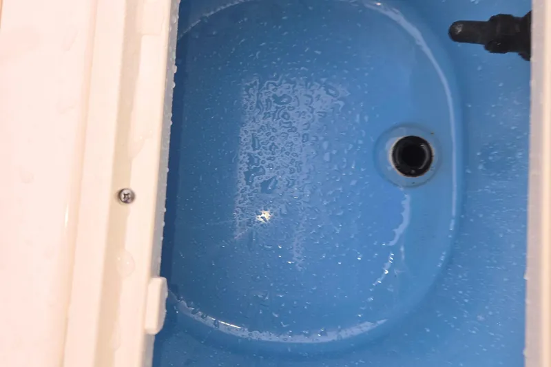 Slide: The Image of 2021 Carolina Skiff 19 LS forward live well with lighting. - 22