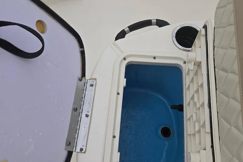 Slide: The Image of Open forward live well on 2021 Carolina Skiff 19 LS boat, featuring blue interior and lighitng - 23