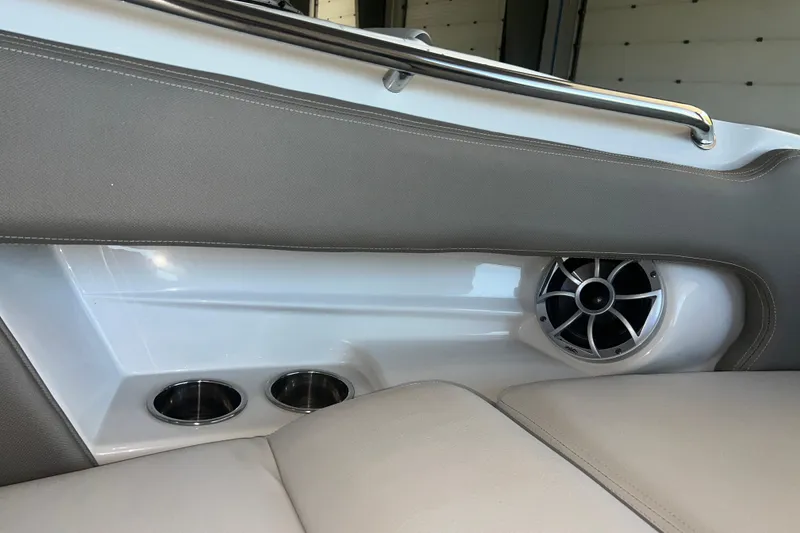 Slide: The Image of 2026 Crownline Eclipse E260 XS boat interior with luxurious seating and speaker system. - 11