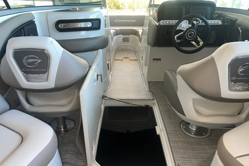 Slide: The Image of Steering wheel of 2026 Crownline Eclipse E260 XS boat with modern dashboard controls. - 14