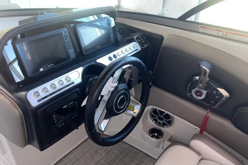 Slide: The Image of Interior of 2026 Crownline Eclipse E260 XS boat, featuring sleek storage compartment and speaker. - 19