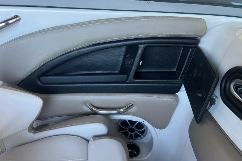 Slide: The Image of 2026 Crownline Eclipse E260 XS boat interior with cushioned seating and built-in speakers. - 23