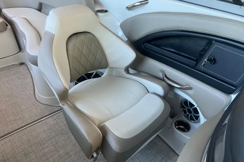 Slide: The Image of Interior of 2026 Crownline Eclipse E260 XS boat, featuring speaker and storage compartment. - 24
