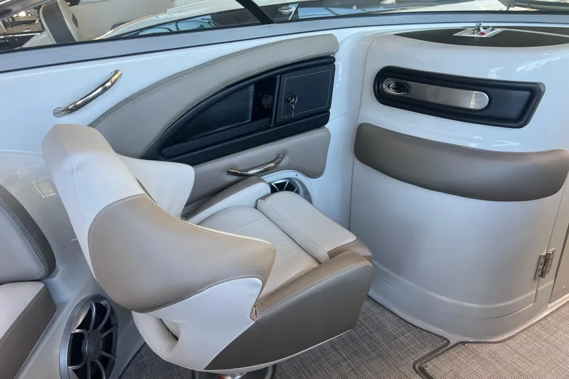 Slide: The Image of 2026 Crownline Eclipse E260 XS boat interior with open storage compartment. - 26