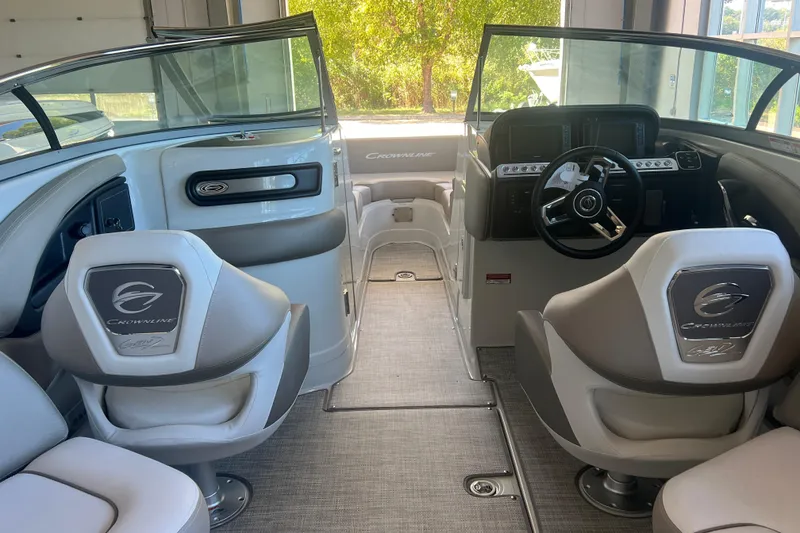 Slide: The Image of 2026 Crownline Eclipse E260 XS boat interior with cushioned seating and elegant design. - 27