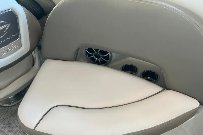 Slide: The Image of 2026 Crownline Eclipse E260 XS boat interior with cushioned seating and cup holders. - 28