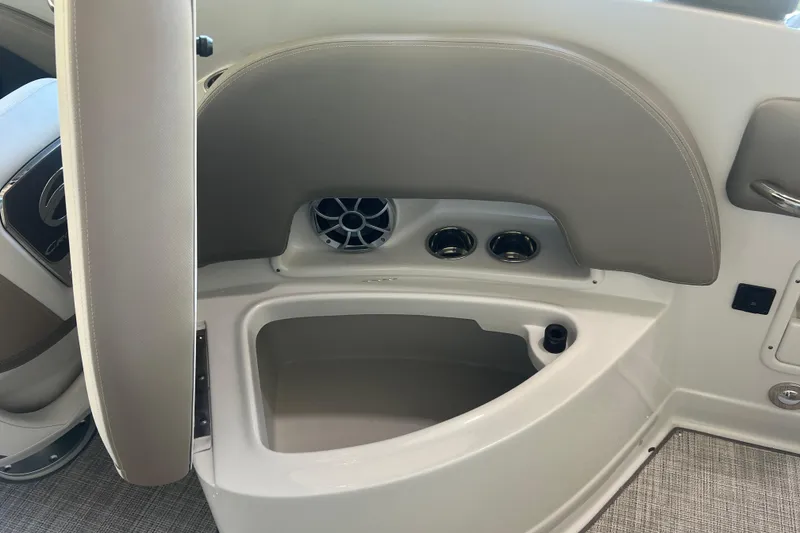 Slide: The Image of 2026 Crownline Eclipse E260 XS boat interior with beige and white cushioned seating. - 29