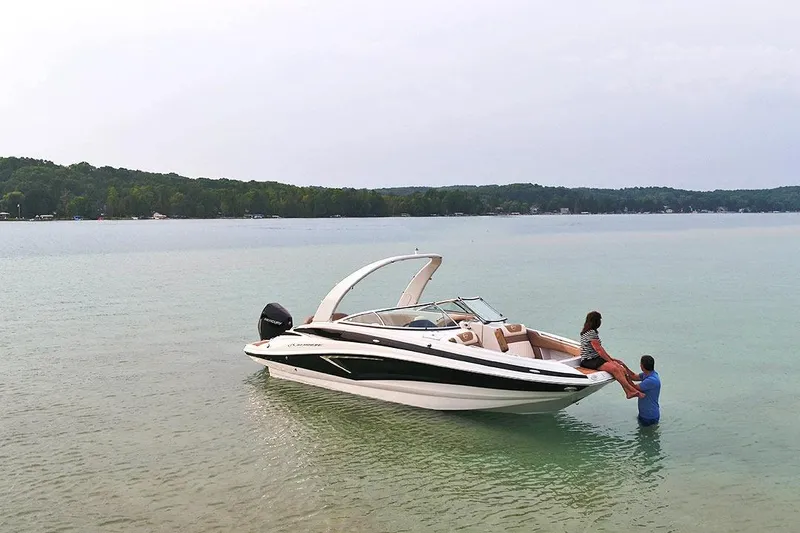 Slide: The Image of 2026 Crownline Eclipse E260 XS boat interior with helm, seating, and storage compartment. - 3