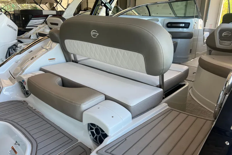 Slide: The Image of 2026 Crownline Eclipse E260 XS boat interior with speakers and canopy in a garage. - 38