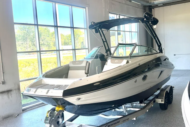 Slide: The Image of Luxurious seating area of 2026 Crownline Eclipse E260 XS boat with cup holders and speakers. - 5