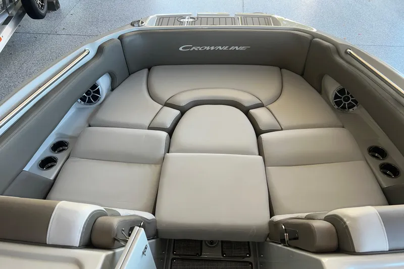 Slide: The Image of 2026 Crownline Eclipse E260 XS boat interior with open storage compartment and cooler. - 7