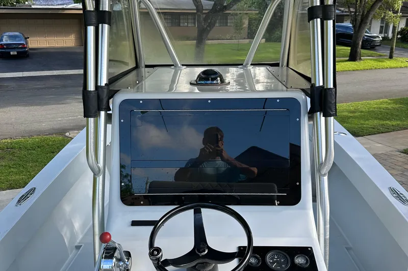 Slide: The Image of 2004 SeaVee Center Console boat dashboard with steering wheel and controls. - 10