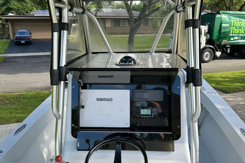 Slide: The Image of 2004 SeaVee Center Console boat dashboard with Simrad navigation system. - 11