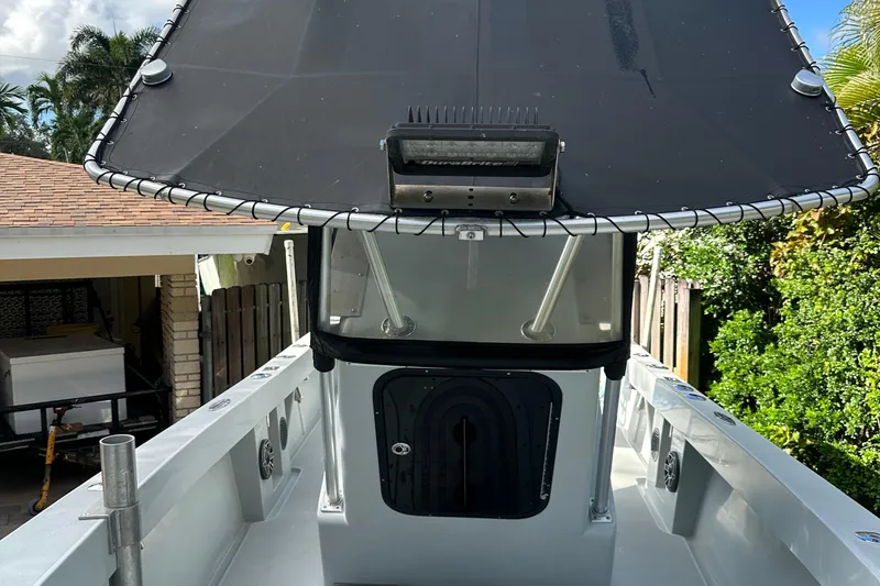 Slide: The Image of 2004 SeaVee Center Console boat with T-top and forward deck view. - 16