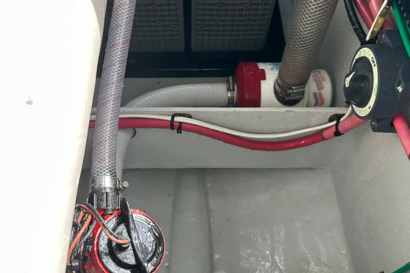 Slide: The Image of 2004 SeaVee Center Console boat wiring and plumbing components in the engine compartment. - 18
