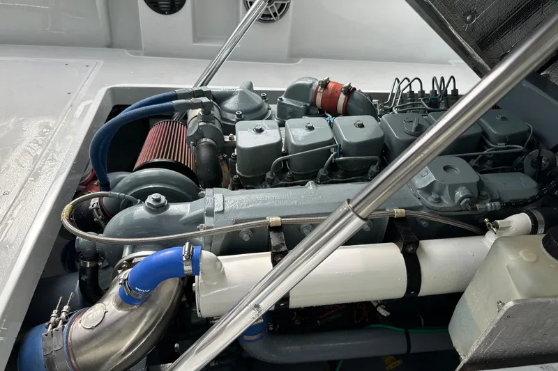 Slide: The Image of 2004 SeaVee Center Console engine compartment with visible components and piping. - 21