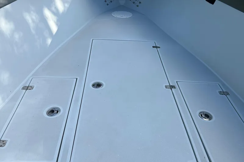 Slide: The Image of 2004 SeaVee Center Console boat deck with storage compartments. - 22