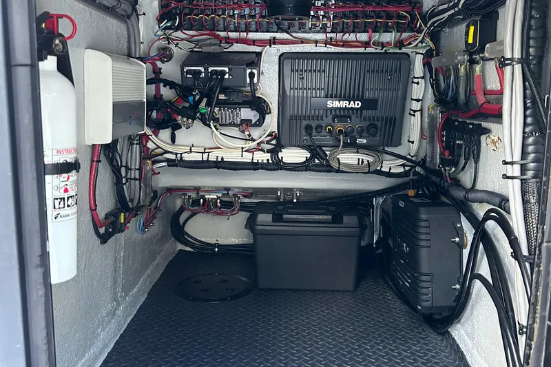 Slide: The Image of 2004 SeaVee Center Console boat electronics compartment with Simrad equipment and wiring. - 26