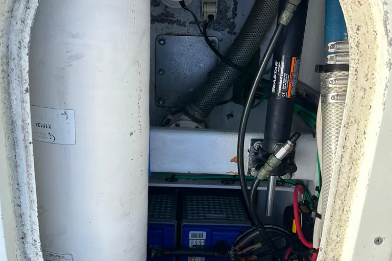 Slide: The Image of 2004 SeaVee Center Consol boat interior showing mechanical components and wiring. - 28