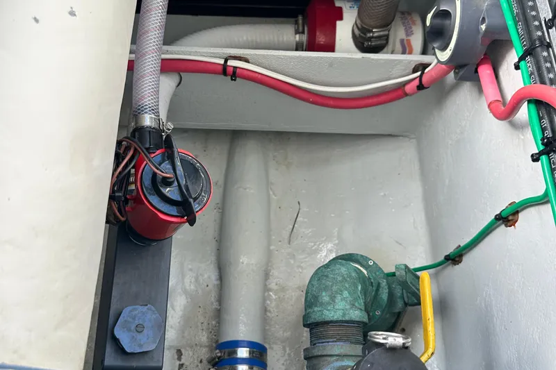 Slide: The Image of 2004 SeaVee Center Console boat interior with visible wiring and plumbing components. - 33