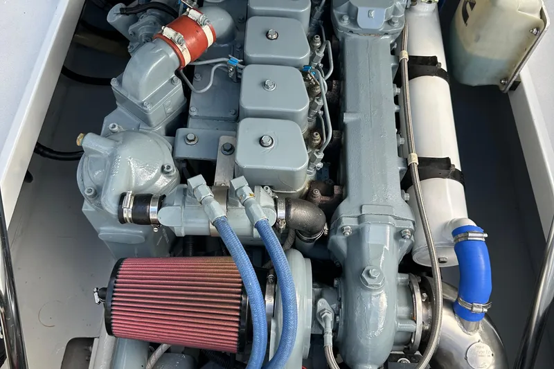 Slide: The Image of 2004 SeaVee Center Consol engine, detailed view with hoses and components. - 35