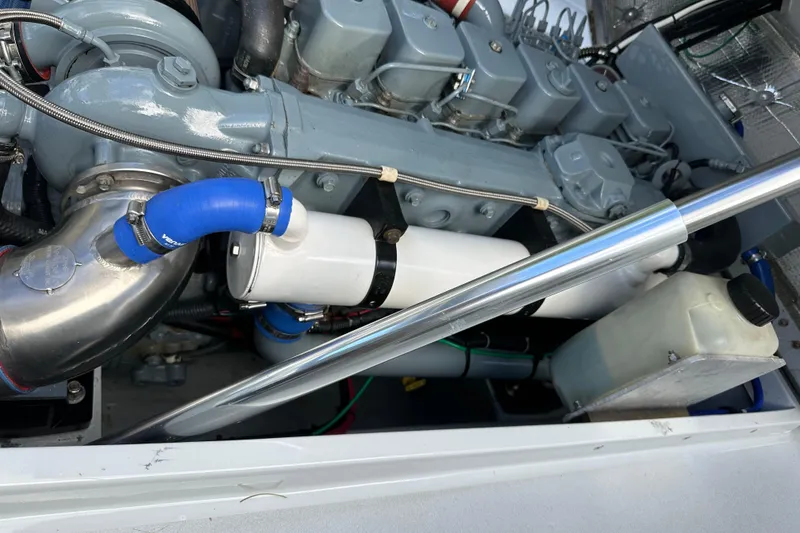 Slide: The Image of 2004 SeaVee Center Console engine with blue hoses and metal components. - 36