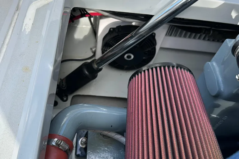 Slide: The Image of 2004 SeaVee Center Consol engine compartment with air filter and hydraulic components. - 37