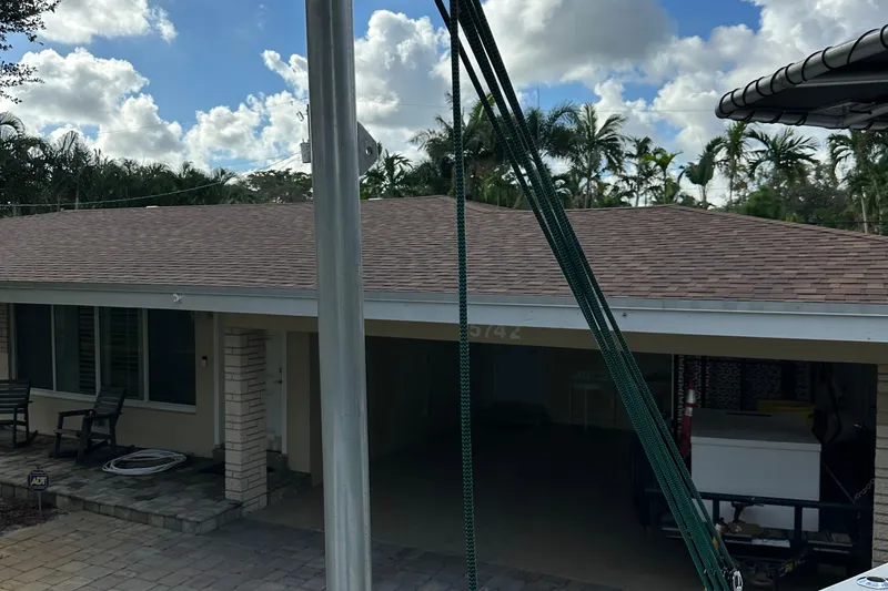 Slide: The Image of House with palm trees, clear sky, and a 2004 SeaVee Center Console boat in the foreground. - 41