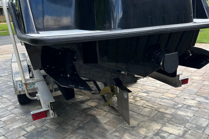 Slide: The Image of 2004 SeaVee Center Console boat on trailer, rear view showing propeller and trim tabs. - 43