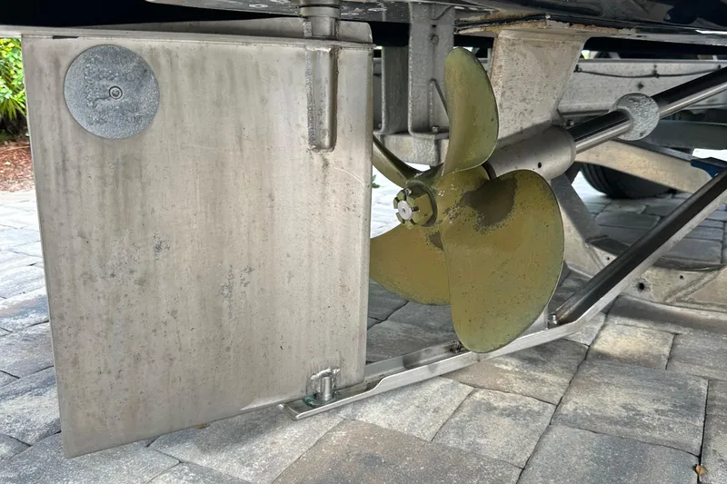 Slide: The Image of 2004 SeaVee Center Consol boat propeller and rudder on a paved surface. - 45