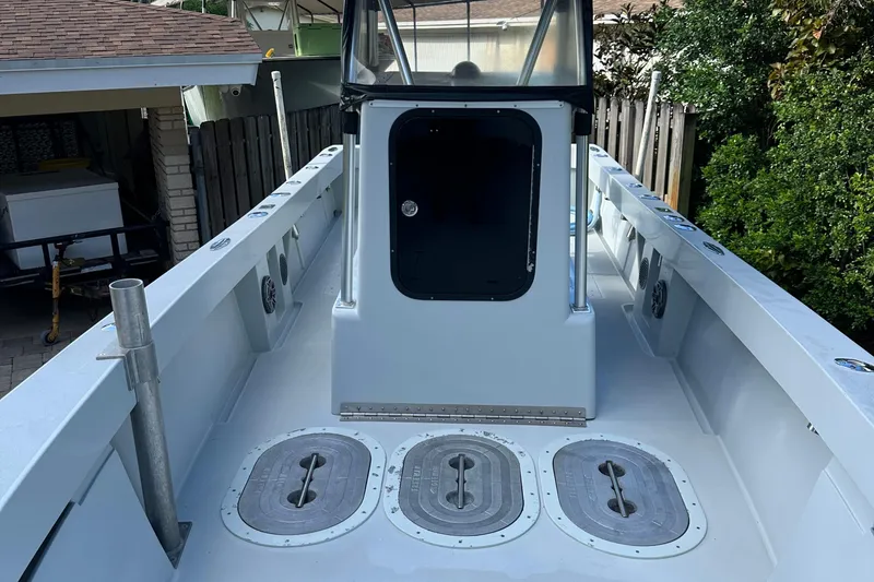 Slide: The Image of 2004 SeaVee Center Console boat deck with storage hatches and console. - 7