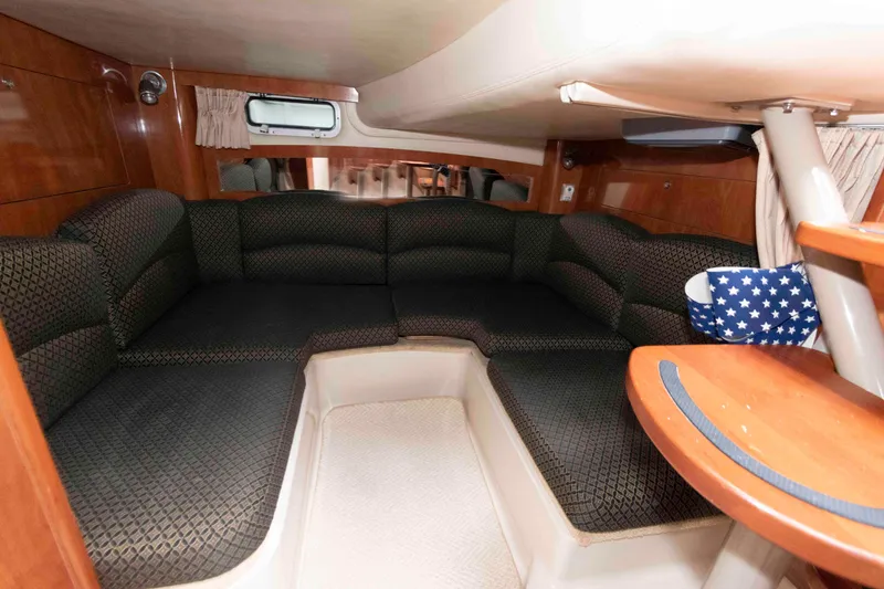 Slide: The Image of Interior of 2006 Four Winns 348 Vista yacht with cozy seating and wooden accents. - 17