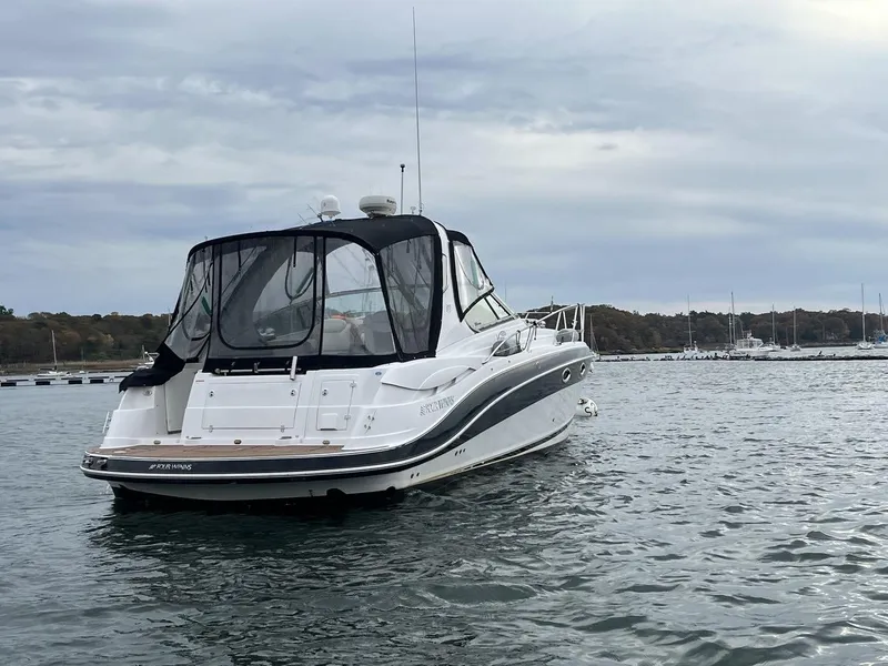 Slide: The Image of 2006 Four Winns 348 Vista boat docked near a waterfront building. - 2