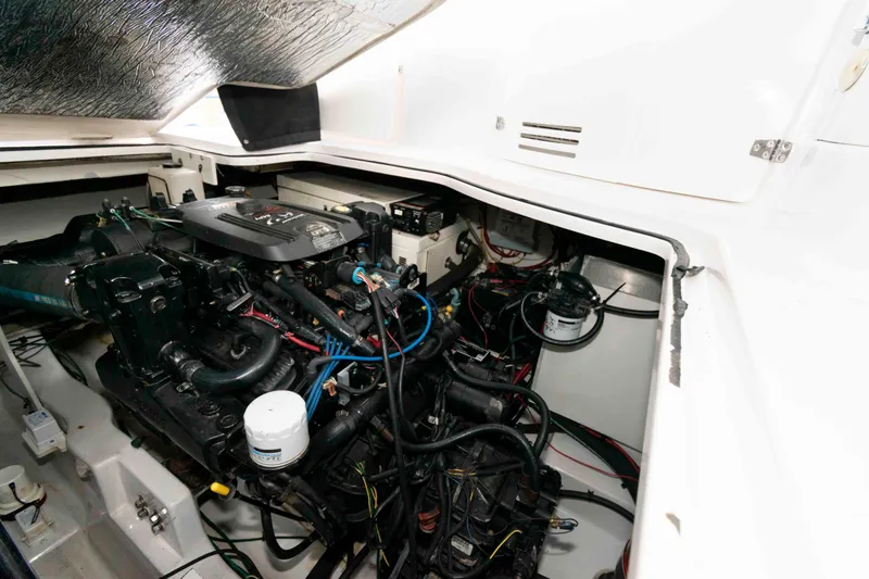 Slide: The Image of Engine compartment of a 2006 Four Winns 348 Vista boat, showcasing detailed mechanical components. - 20