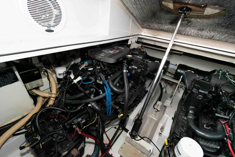 Slide: The Image of Engine compartment of a 2006 Four Winns 348 Vista boat, showcasing mechanical components. - 21