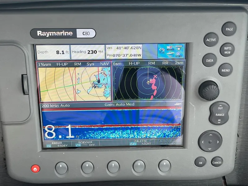 Slide: The Image of 2006 Four Winns 348 Vista boat helm with steering wheel and navigation controls. - 8