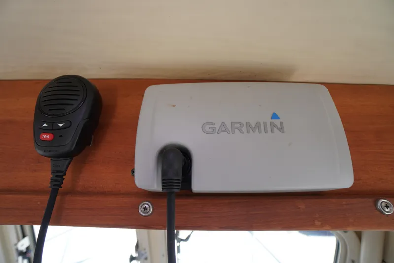 Slide: The Image of Garmin device and microphone in 2016 Rosborough 246 Dingby boat interior. - 10