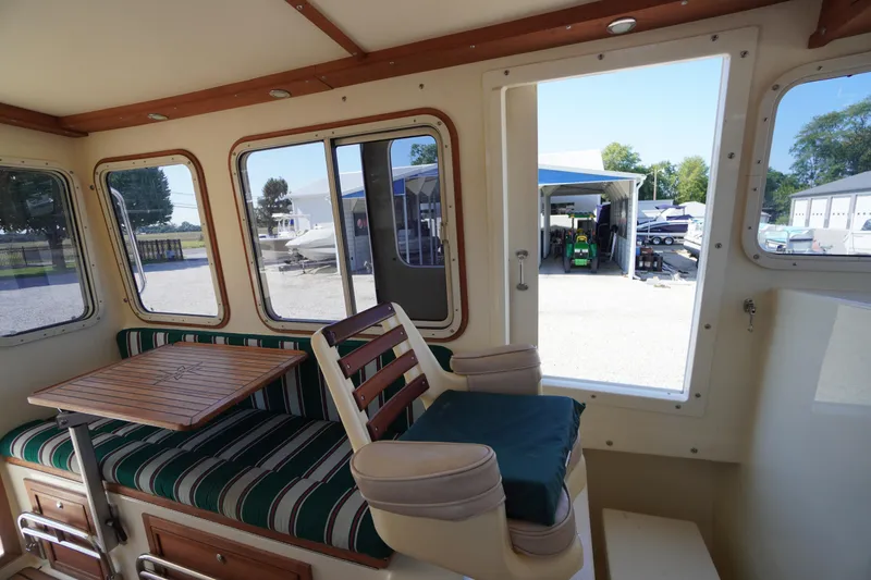 Slide: The Image of Interior of 2016 Rosborough 246 Dingby boat with striped seating and wooden table. - 13