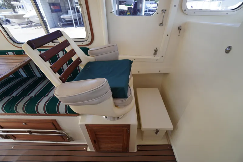 Slide: The Image of Interior of 2016 Rosborough 246 Dingby boat with cushioned seating and wooden accents. - 14