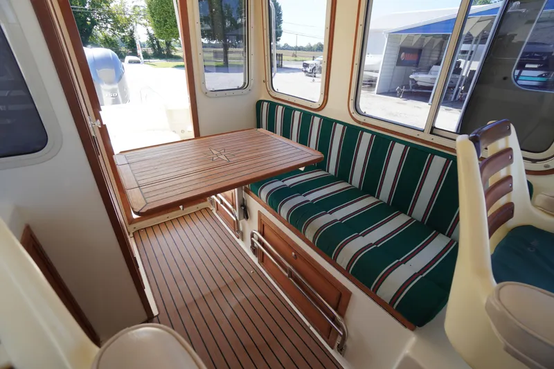 Slide: The Image of Interior of 2016 Rosborough 246 Dingby boat with striped seating and wooden table. - 18