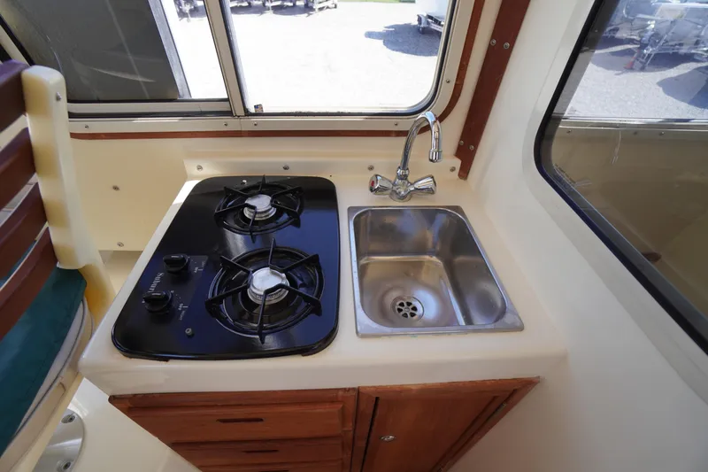 Slide: The Image of Compact kitchen area in 2016 Rosborough 246 Dingby with stove and sink. - 20